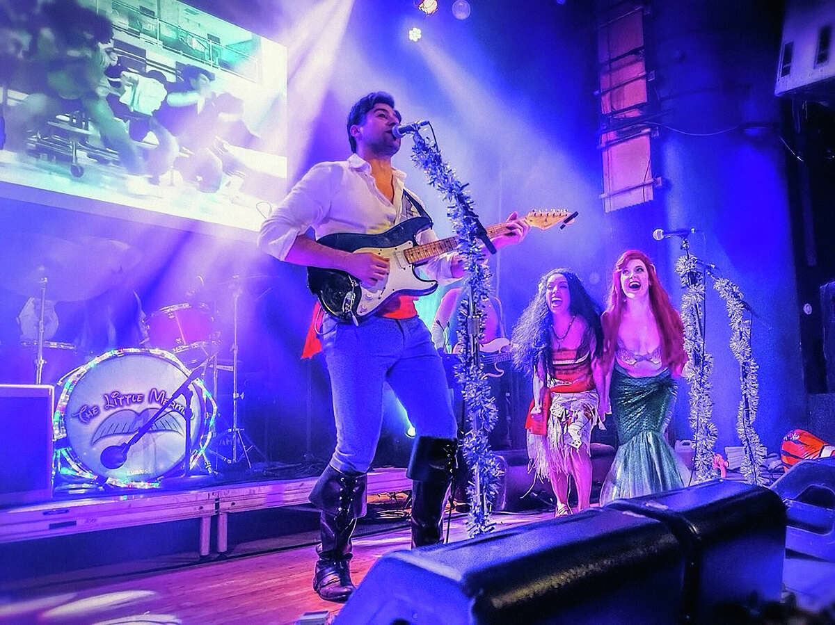 The Little Mermen include (from left) lead singer and guitarist Alexis Babini as Prince Eric from The Little Mermaid, Chelsea Zeno as Moana, and Carly Kincannon as Ariel.