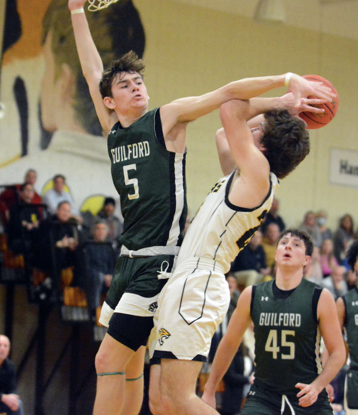 Guilford's Justin Hess blocks a shot by Sam Markovitz of Hand during their SCC boys basketball game Thursday, Jan. 19, 2023.
