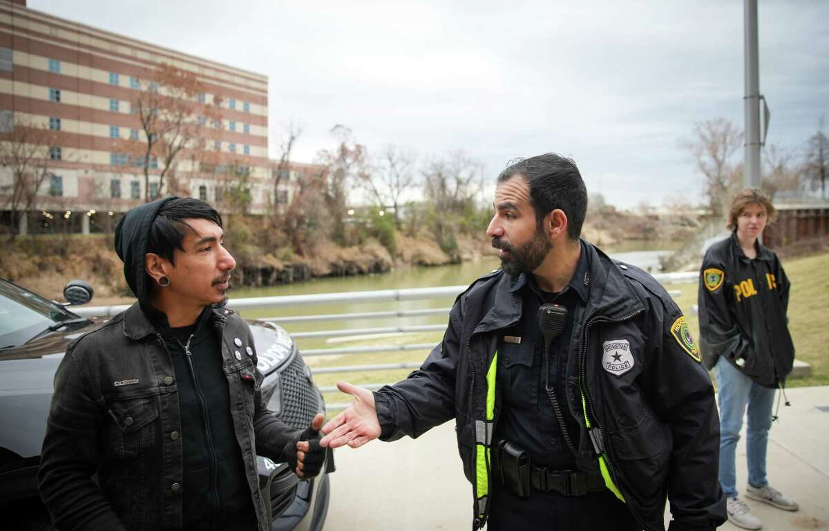 Richard Molina, left, talks with Jesus Robles, center, after Molina spoke to a group of Houston Police cadets Friday, Jan. 20, 2023, at Joe Campos Torres Pavilion in Houston. Molina spoke to the cadets at the location, where in 1977 Houston Police officers killed his uncle Campos Torres.