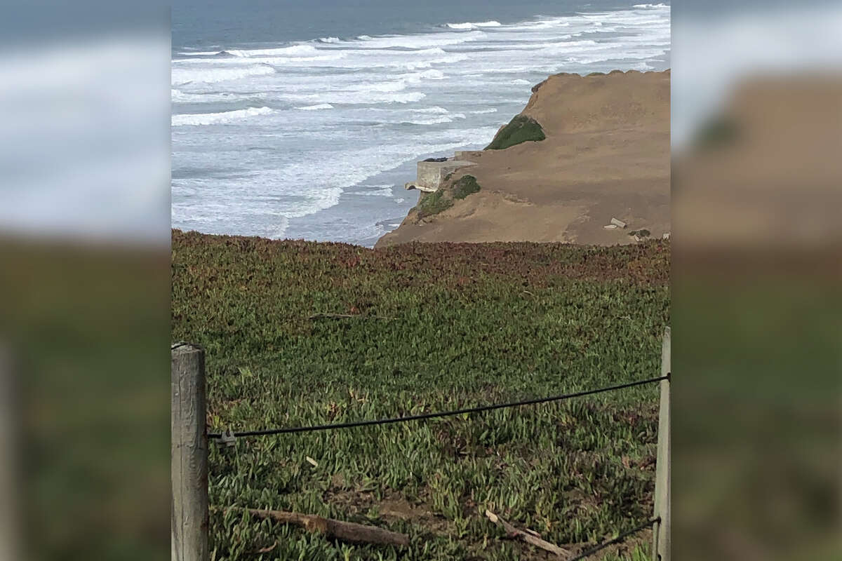 A WW II bunker was photographed in December 2022, sitting on the edge of the cliffs above San Francisco’s Fort Funston. The bunker fell onto the beach on Jan. 16, 2023; there were no injuries.