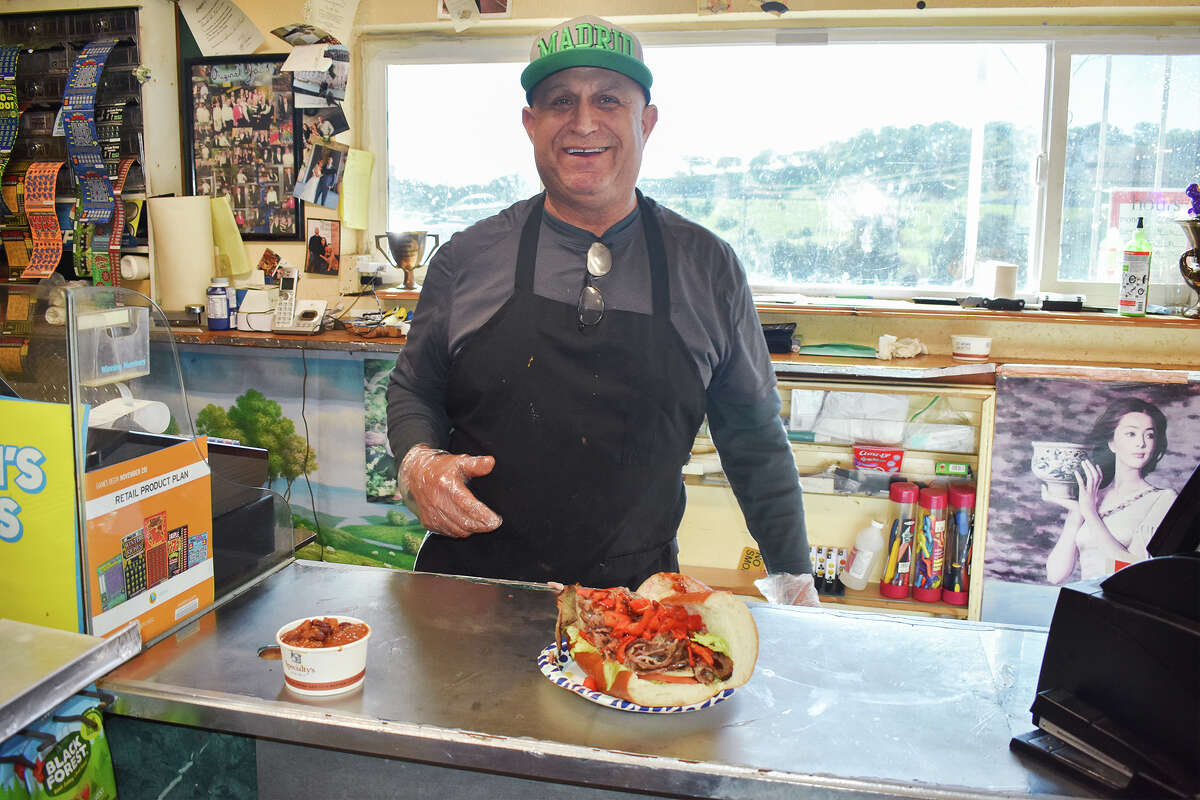 Martin Muñoz, owner of Prunedale Market & Deli, serves up the store's signature tri-tip sandwich on Jan. 18, 2023.