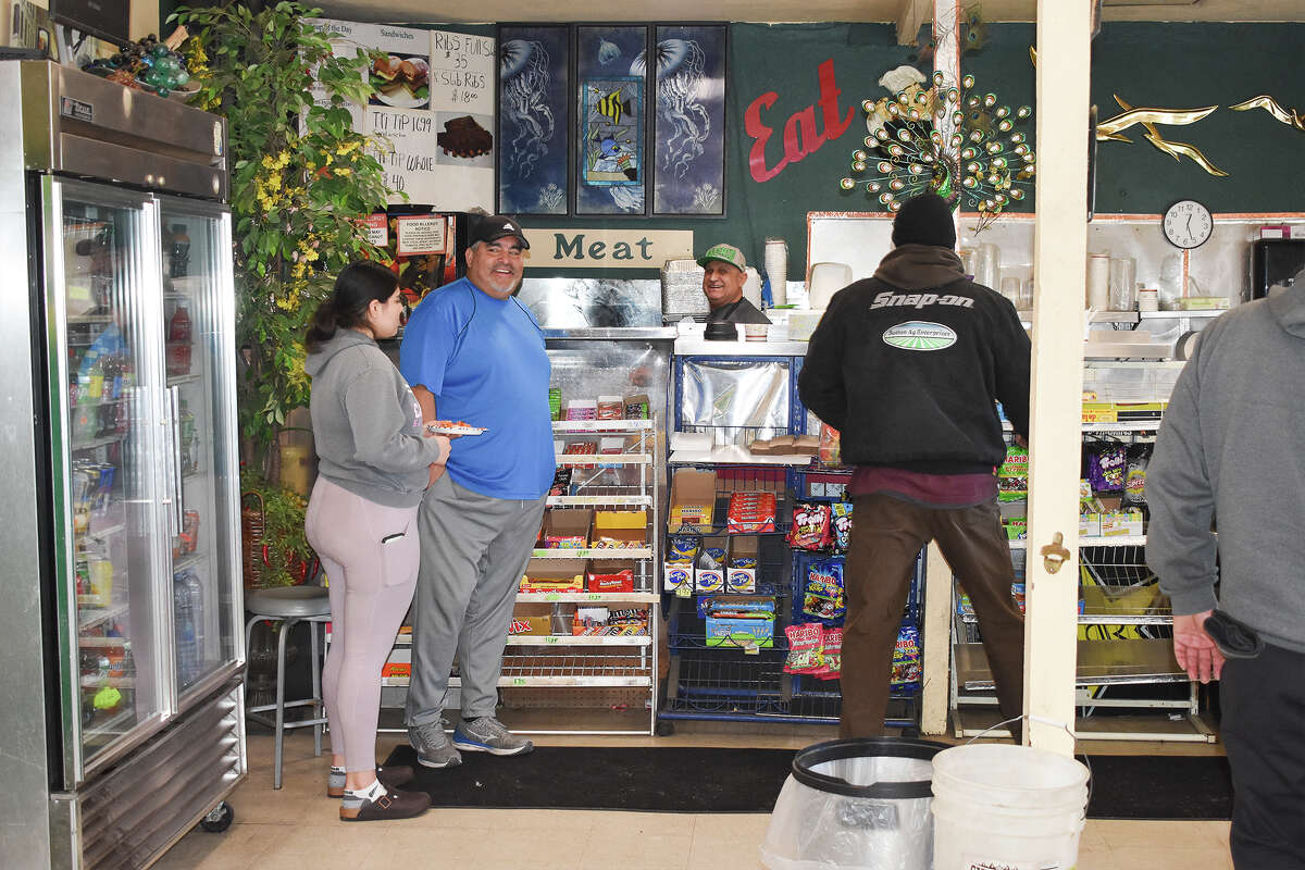 Customers at Prunedale Market & Deli talk while waiting for their food on Jan. 18, 2023. 