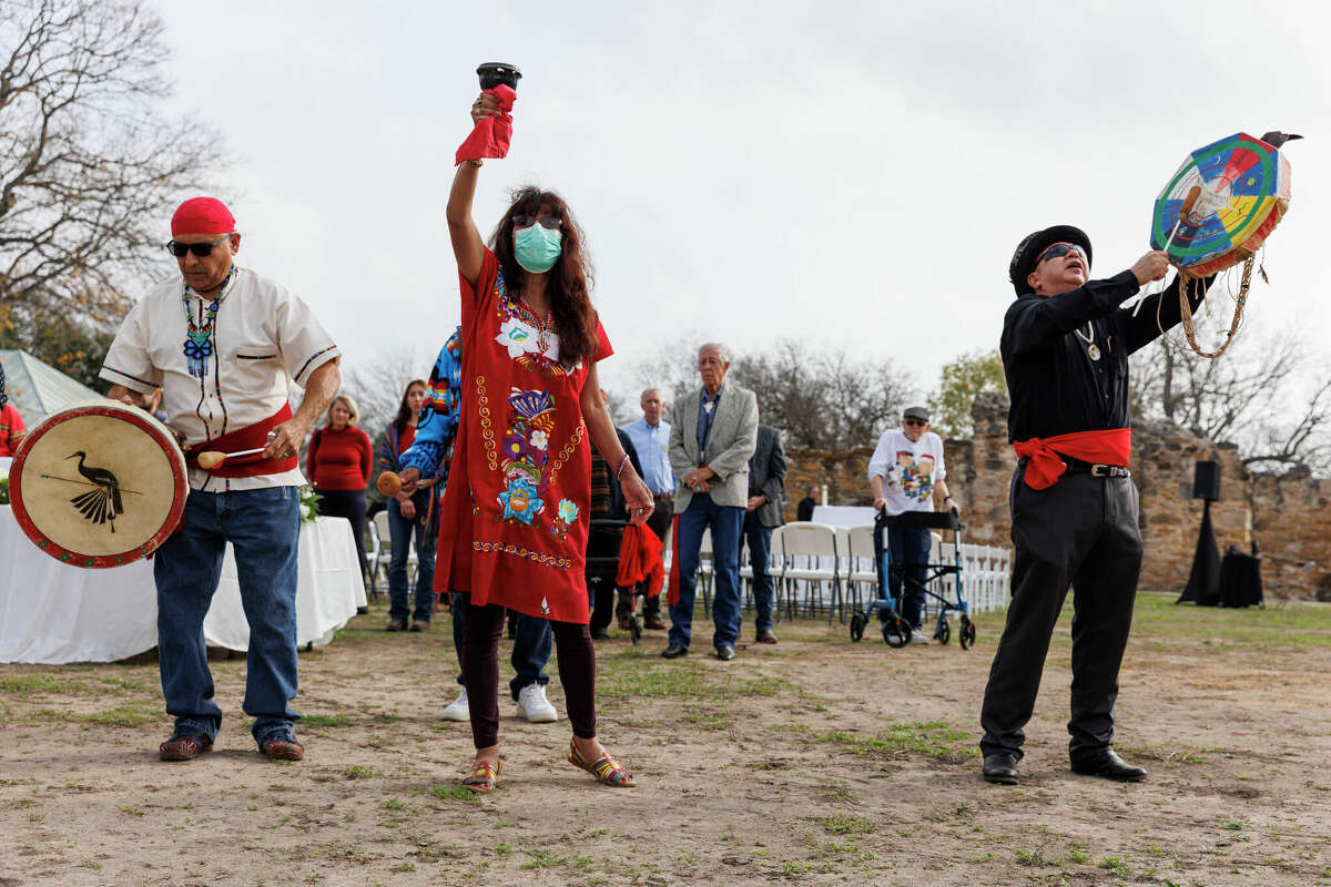 John and Barbara Hernandez and Ricky Reyes, all members of the Native American educational group Danza Azteca de Yanaguana, sing as they blesses ancestral human remains before attending a memorial mass lead by Archbishop Gustavo Garci­a-Siller at Mission San Juan in San Antonio on Friday, Dec. 9, 2022. The human remains were found at the missions through past archaeological and remodeling projects and were reburied on the grounds following the ceremony.