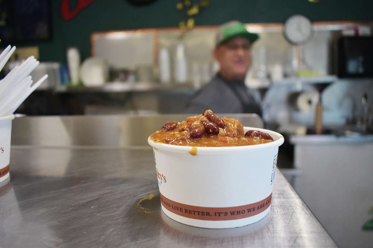 Martin Muñoz slides over a cup of chili, one of his daily special soups at Prunedale Market & Deli, on Jan. 18, 2023. 