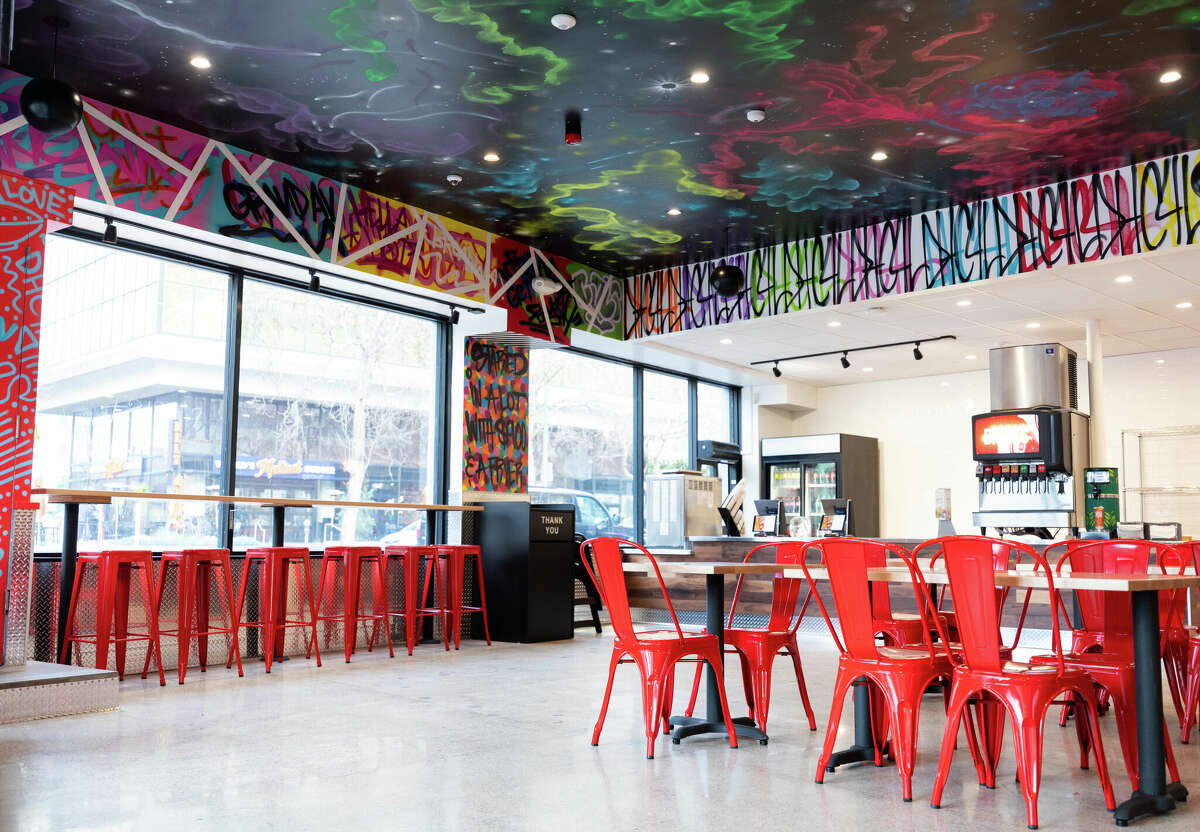 The dining room inside Dave's Hot Chicken in Oakland features the chain's signature wall-to-wall street art.