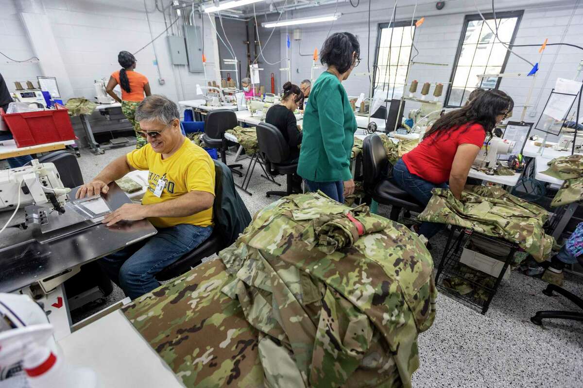 Jesus Hernandez, left, one of the blind employees at San Antonio Lighthouse for the Blind and Vision Impaired, sews military uniform components Wednesday, Jan. 18, 2023, at the non-profit organization’s Roosevelt Avenue facility.