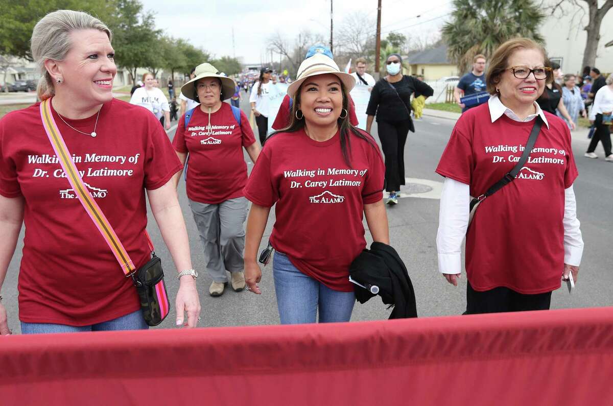 Almie Pachoco-Latimore (center) takes part in Monday’s MLK March with the Alamo Trust. They marched to honor her husband, Carey Latimore, a beloved Trinity history professor and voice for civil rights and Alamo Trust adviser.