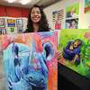 Nurse practitioner and professional artist Payal Emery, of Milford, with some of her fanciful animal portraits at the Firehouse Art Gallery in Milford, Conn. on Friday, January 20, 2023.