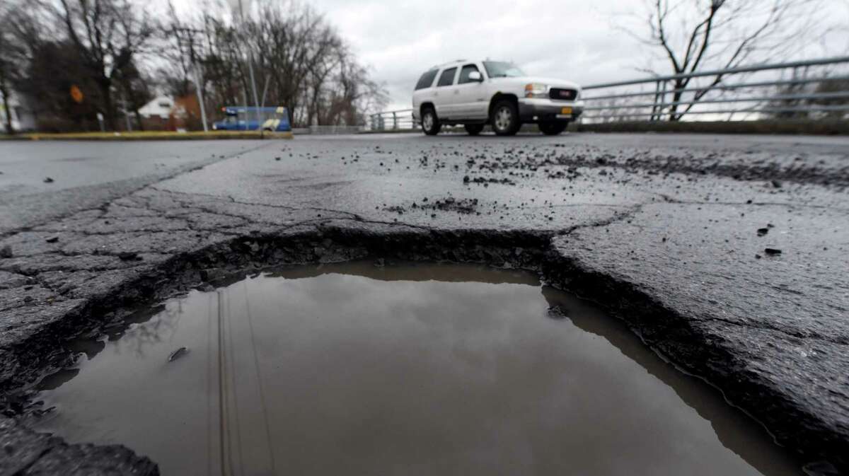 A large pothole sits in the middle of Northern Blvd. on Friday, Jan. 20, 2023, in Albany, N.Y.