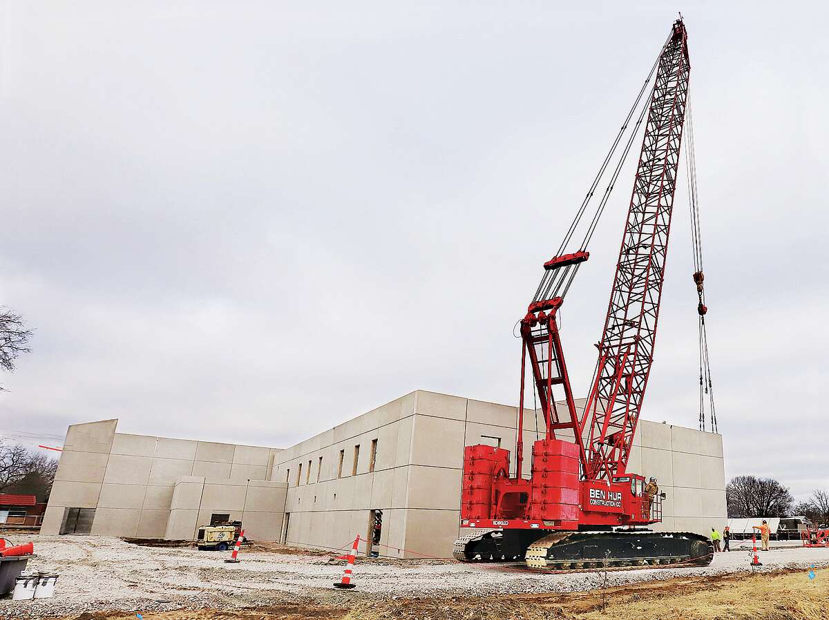 John Badman|The Telegraph A large crane from Ben Hur Construction Co. in St. Louis sets another slab wall into place Friday at the Wood River Recreation Center project.