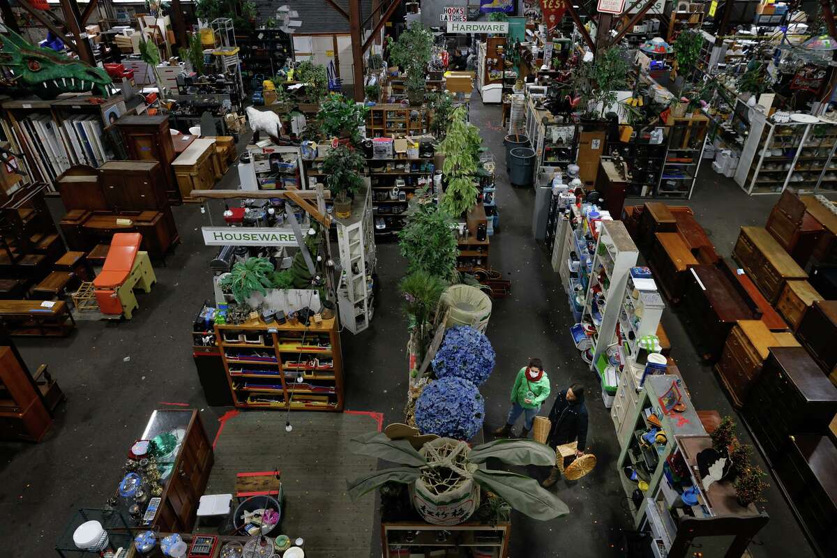 Customers shop in the aisles at Urban Ore in Berkeley.