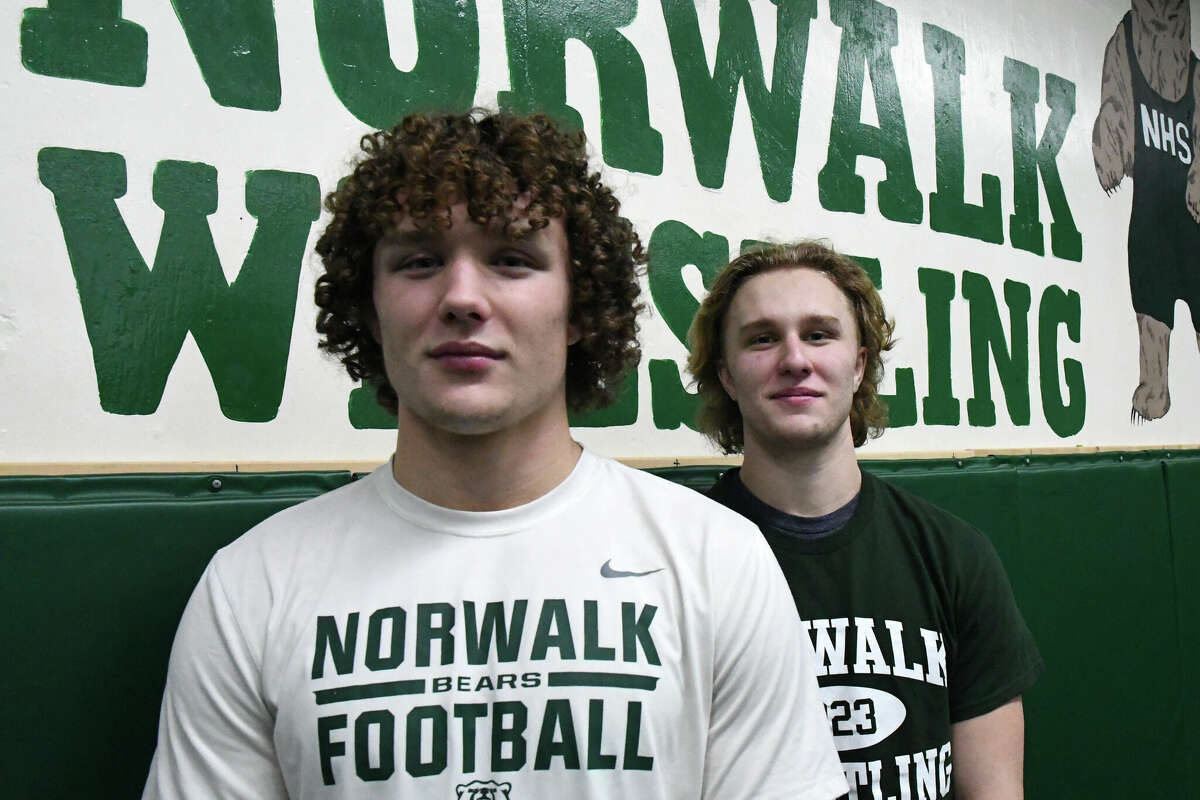 Norwalk's Brendan Gilchrist, left, and his brother Ryan Gilchrist pose for a photo during wrestling practice at Norwalk High School, Norwalk on Thursday, Jan. 19, 2023.
