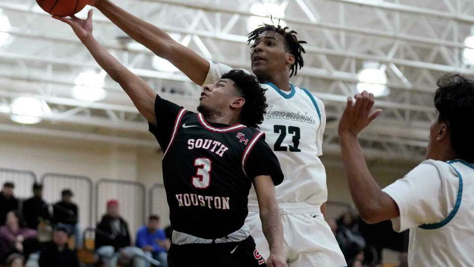 Pasadena Memorial forward Robert Miller III (23) blocks the shot of South Houston guard Joseph Buckner during the first half of a high school basketball game, Friday, Jan. 20, 2023, in Pasadena.