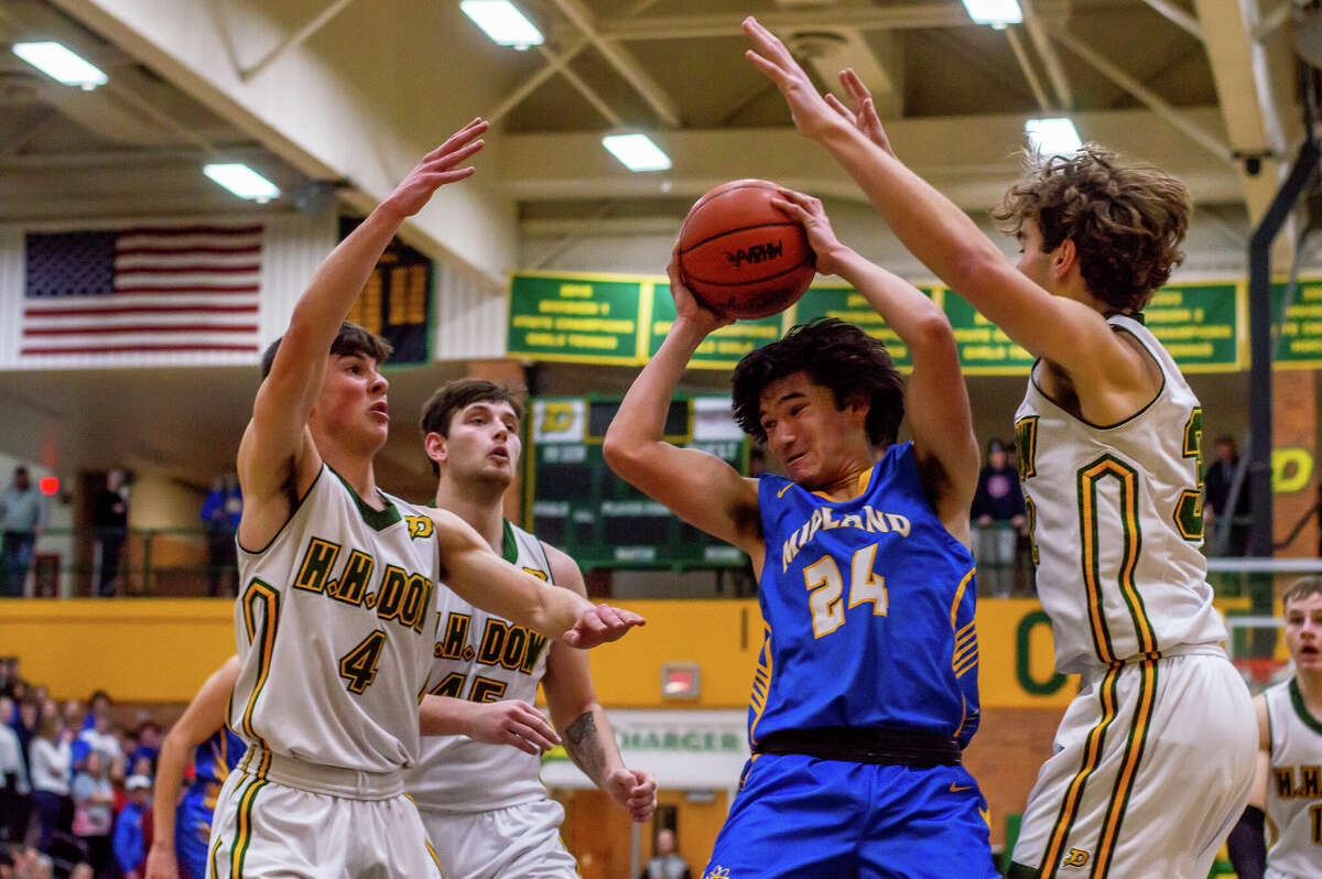 Midland High's Josh Thurlow pulls down a rebound during Friday's game against Dow High, Jan. 20, 2023.