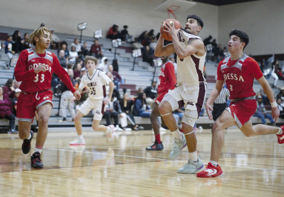 Legacy's Max Vera makes his move toward the hoop while being guarded by Odessa High's Xavier Brooks (33) and Adrian Muzquiz (right) during a District 2-6A boys basketball game, Jan. 20 at Rebel Gymnasium. 