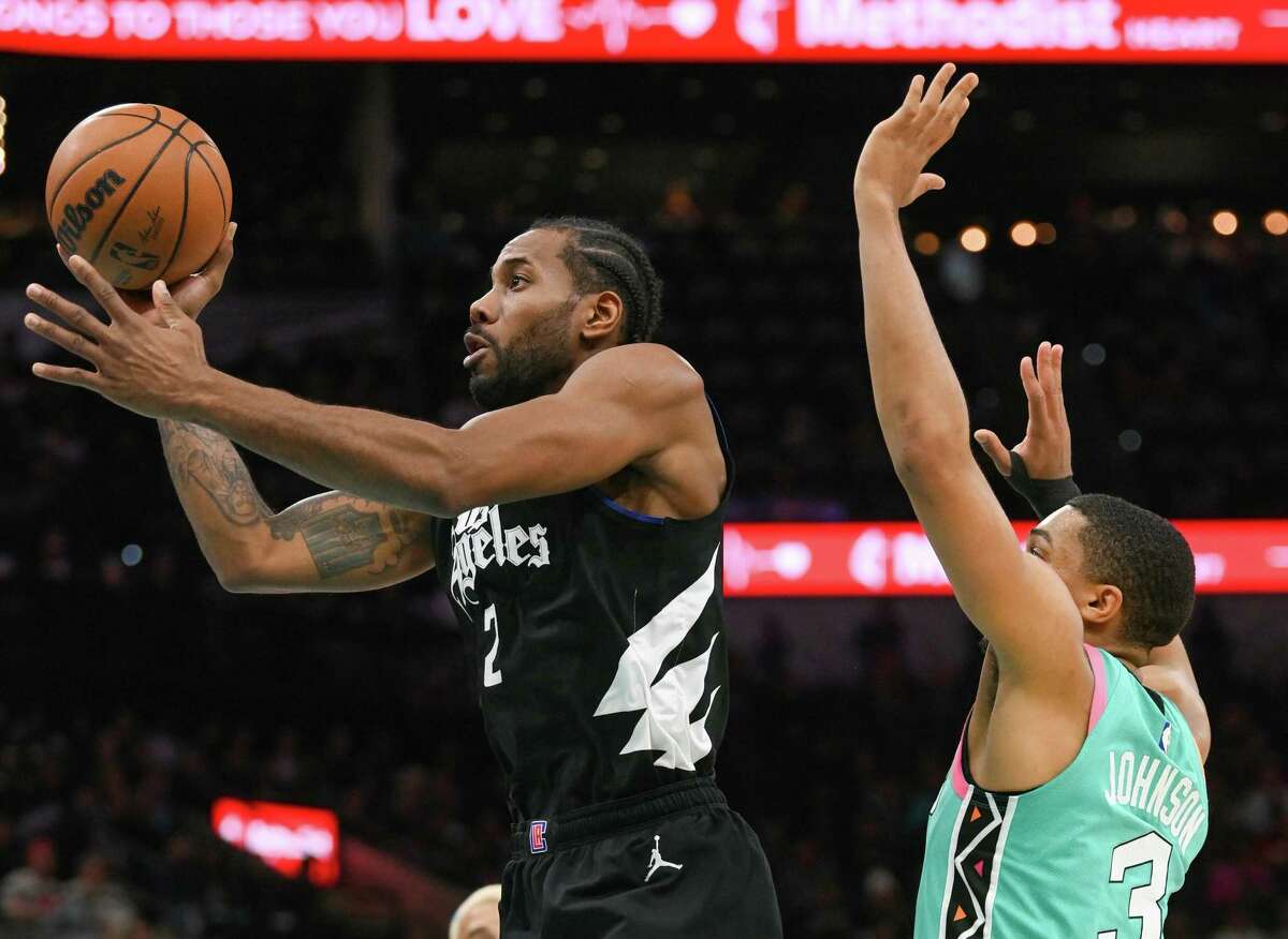 Kawhi Leonard of the Los Angeles Clippers (2) who formerly played with the Spurs, is guarded by Keldon Johnson of the Spurs during NBA action in the AT&T Center on Friday, Jan. 20, 2023.