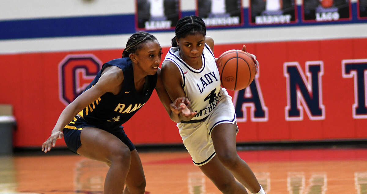 Cy Springs senior point guard Larsyn Catalon-Boldon (4) drives to the hoop against Cy Ranch senior shooting guard Ny'Kyiah Jeffery (15) during the first quarter of their District 16-6A matchup at Cy-Springs High School on Jan. 20, 2023.
