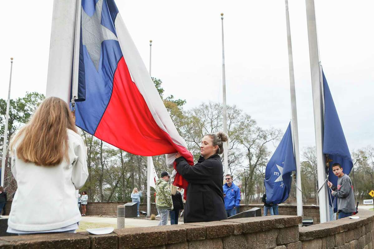 Melissa Gilsdorf, right, and her daughter, Addison Cruce, prepare the Texas state flag to be raises during a flag-raising ceremony in celebration of the 184th anniversary of the Texas state flag, Saturday, Jan. 21, 2023, in Conroe. The official flag of Texas was adopted by the Third Congress of the Republic of Texas on Jan. 25, 1839, in Houston.
