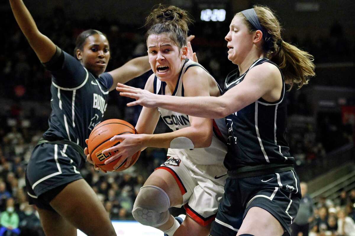 UConn's Lou Lopez-Senechal, center, drives to the basket as Butler's Rachel McLimore, right, defends in the first half of an NCAA college basketball game, Saturday, Jan. 21, 2023, in Storrs, Conn. (AP Photo/Jessica Hill)