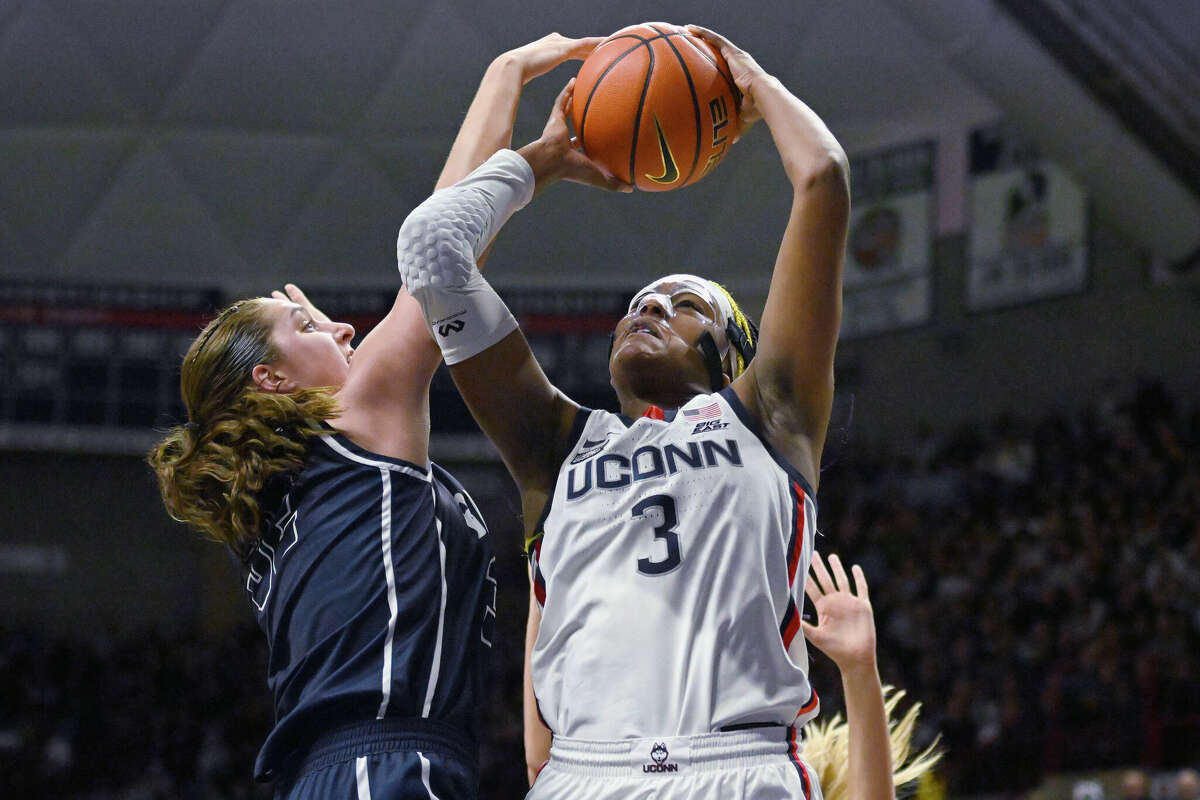 UConn's Aaliyah Edwards, right, is fouled by Butler's Sydney Jaynes in the first half of an NCAA college basketball game, Saturday, Jan. 21, 2023, in Storrs, Conn. (AP Photo/Jessica Hill)