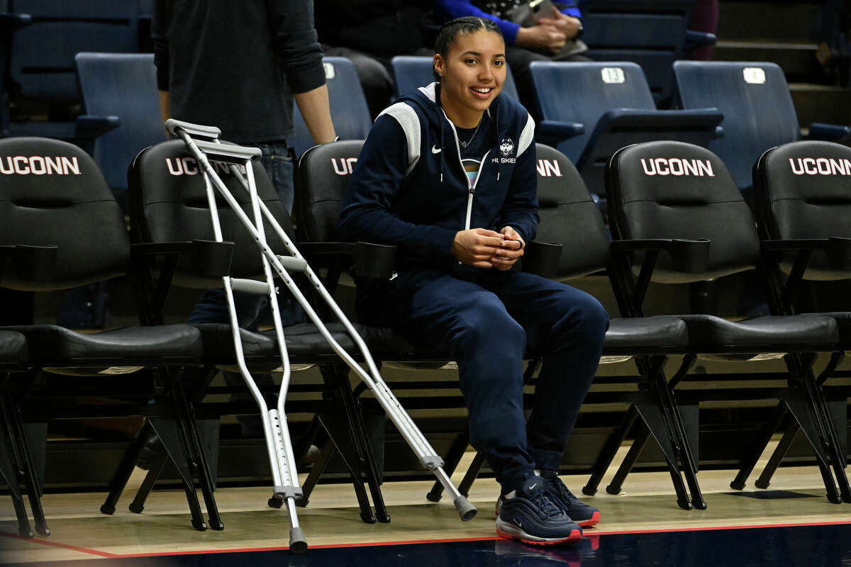 UConn's Azzi Fudd watches her team warm up as she sits out with a knee injury before an NCAA college basketball game against Butler, Saturday, Jan. 21, 2023, in Storrs, Conn. (AP Photo/Jessica Hill)
