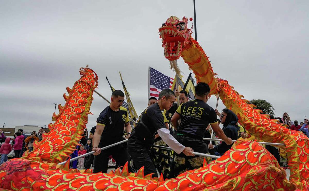 A crowd of people watch Lee’s Golden Dragon Dance Team perform in Katy Asian Town to celebrate the Lunar New Year on Friday, Jan. 20, 2023 in Houston.