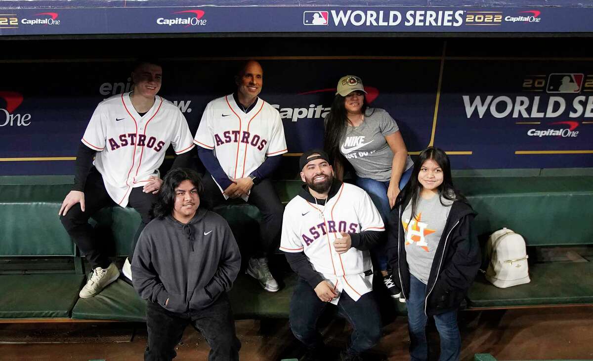 Houston Astros Hunter Brown, bench coach Joe Espada, and Jose Urquidy take photos in the dugout with fans during the Astros FanFest at Minute Maid Park on Saturday, Jan. 21, 2023 in Houston.