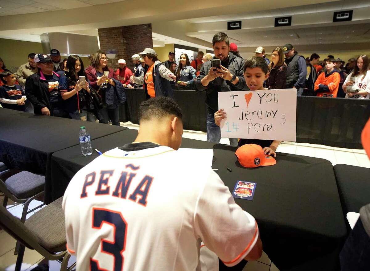 Jairo Martinez, 9, holds up an “I love Jeremy Peña” sign as he waited to get an autographed card from Houston Astros shortstop Jeremy Peña during the Astros FanFest at Minute Maid Park on Saturday, Jan. 21, 2023 in Houston.