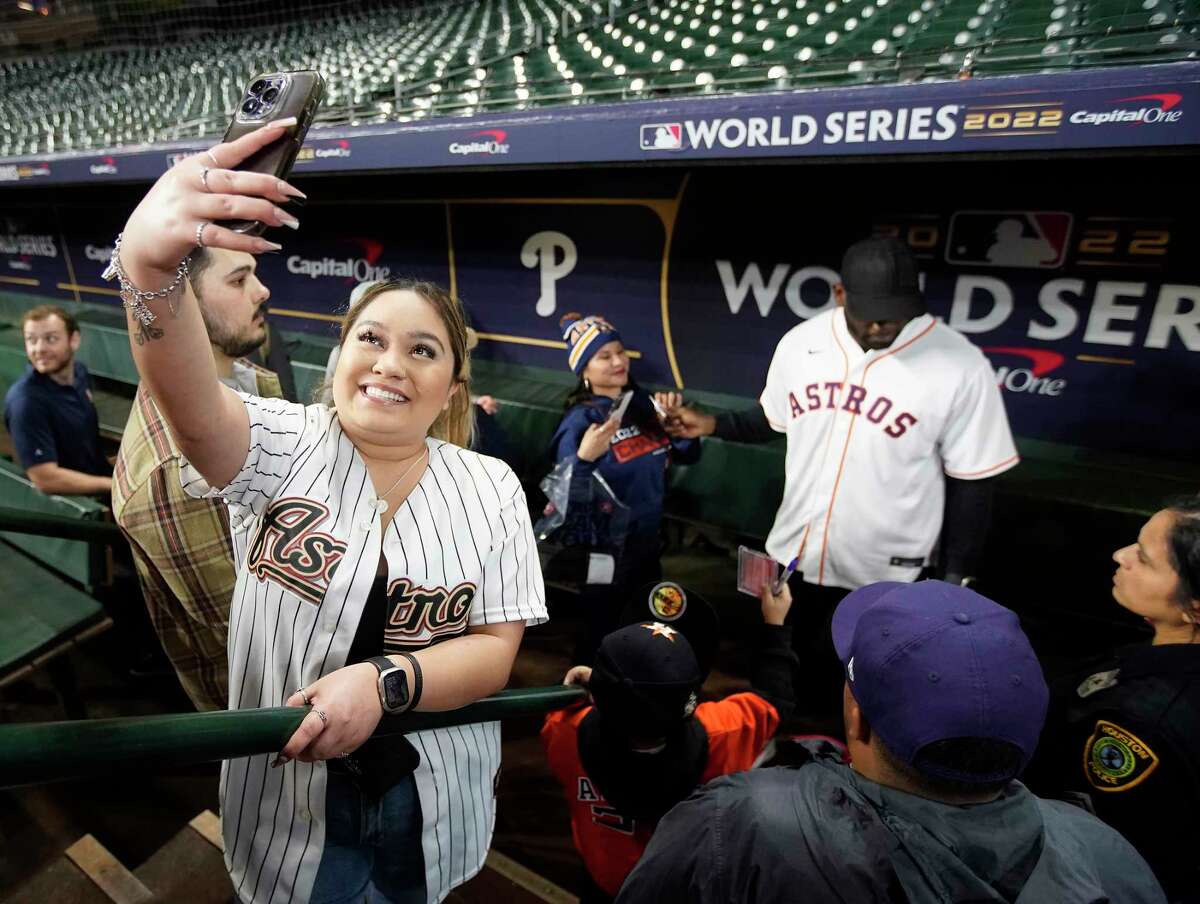 Audrey Garcia takes a selfie as Houston Astros Yordan Alvarez took photos with fans in the dugout during the Astros FanFest at Minute Maid Park on Saturday, Jan. 21, 2023 in Houston.
