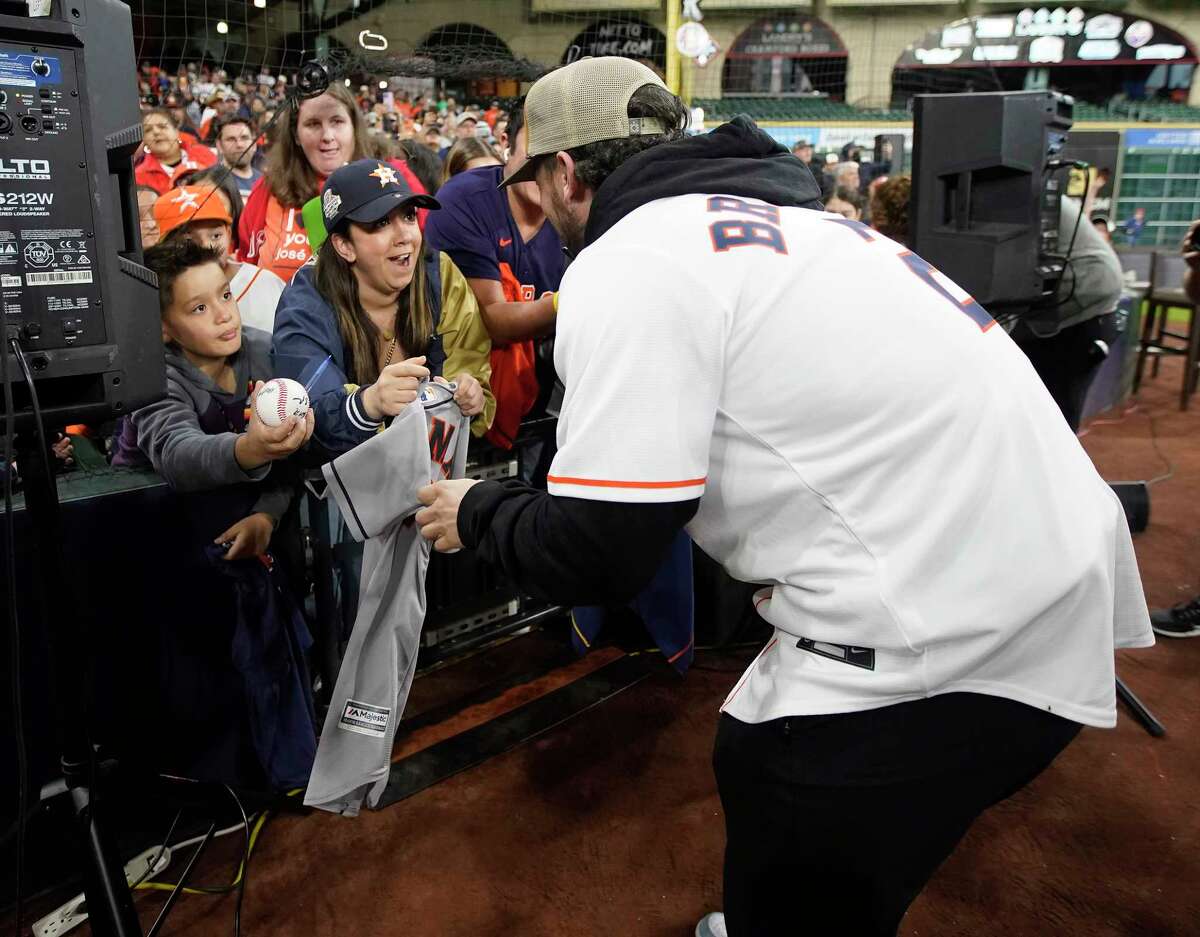 Fans scramble to get an autograph from Alex Bregman during the Astros FanFest at Minute Maid Park on Saturday, Jan. 21, 2023 in Houston.