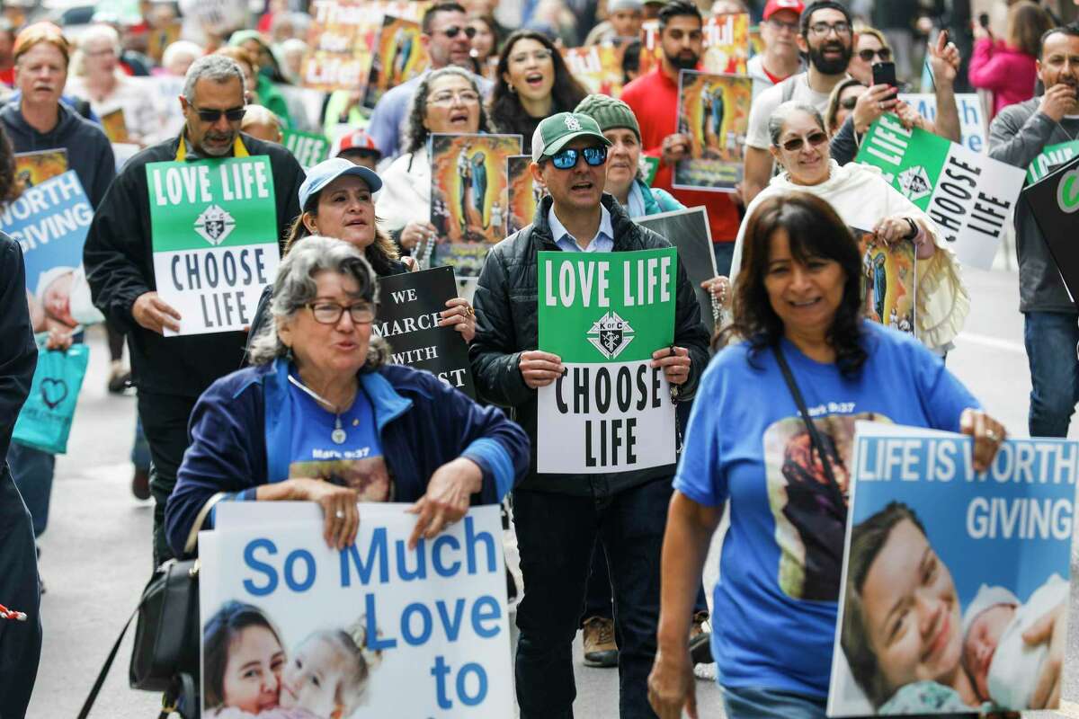 People walk through downtown San Antonioas they participate in the March for Life rally Saturday, Jan. 21, 2023.