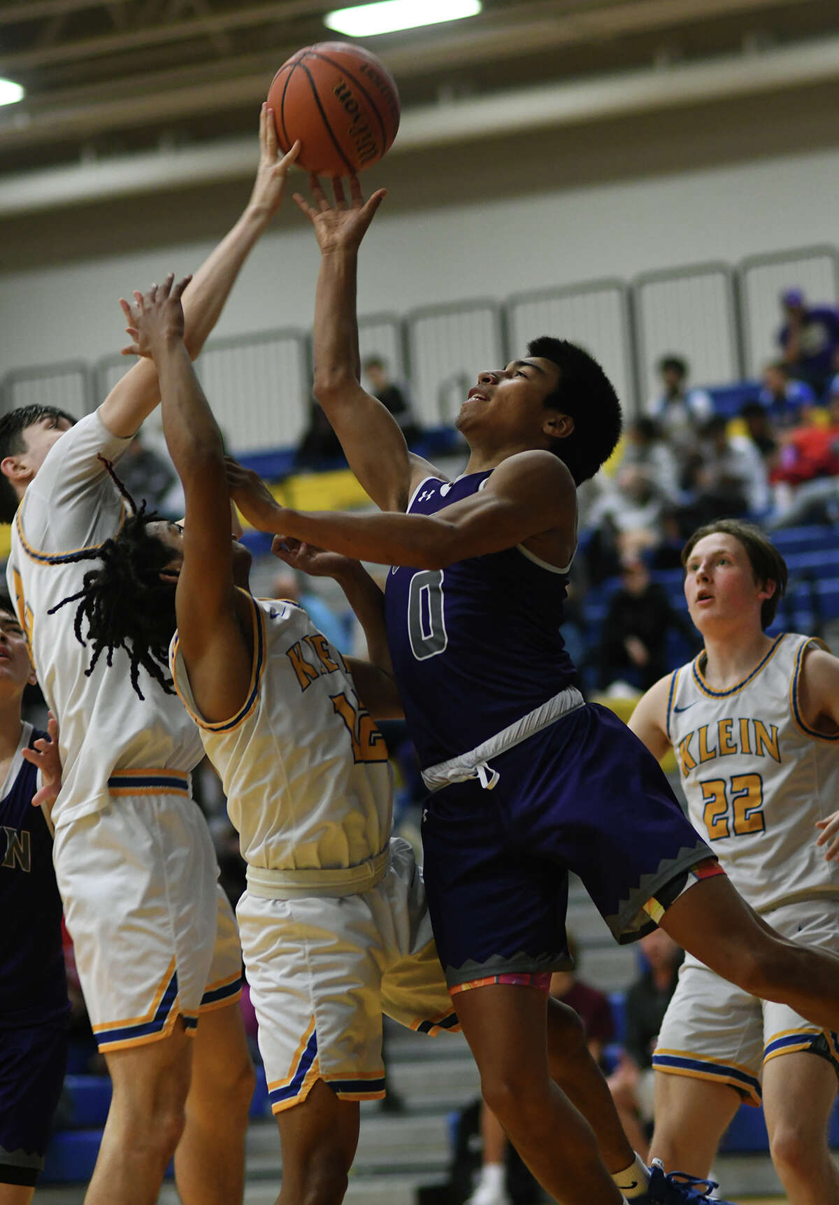Klein Cain senior guard Emmanuel Sosa (0) finds his path to the basket blocked by the taandem of Klein defenders Aaron Martin (12) and Landon Louis, left, both seniors, during the third quarter of their District 15-6A matchup at Klein High School on Jan. 21, 2023.