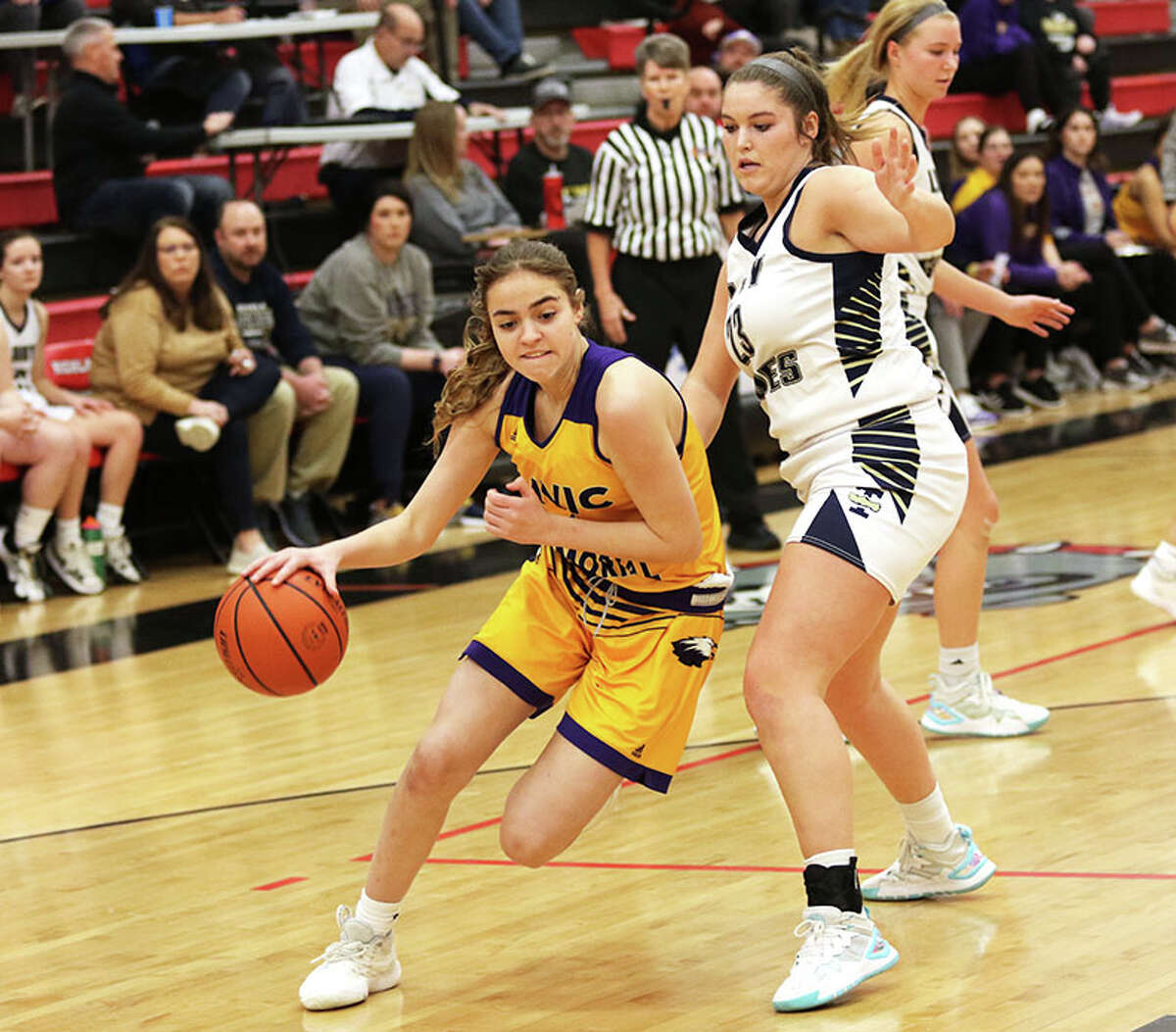 CM's Bella Thien (left) drives past Teutopolis' Kaylee Niebrugge on Saturday in the fifth-place game at the Highland Apex Network Tournament.