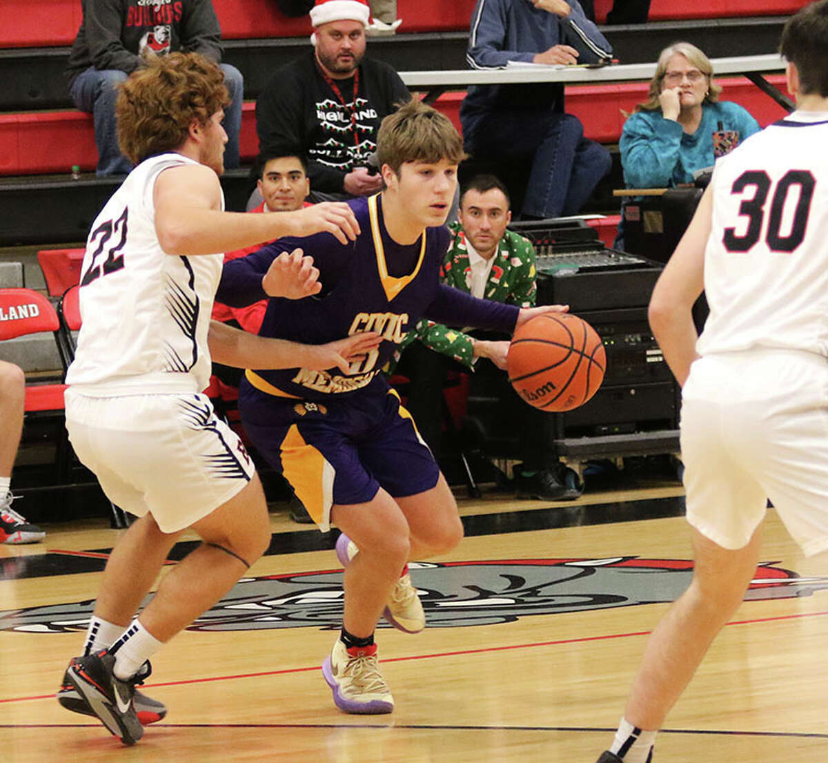 CM's Adam Ogden (middle), shown being guarded by Highland's Cade Altadonna (22) in a Dec. 19 game at Highland, scored a career-high 31 points in Friday's semifinal win at the Litchfield Tourney. On Saturday, CM lost to Triad in the title game, with Ogden earning all-tourney honors.