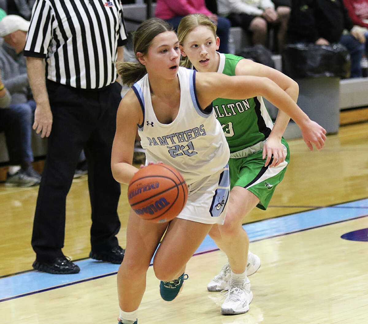 Jersey junior Tessa Crawford (left) drives past Carrollton's Ella Stumpf in a game earlier this month in Jerseyville. On Saturday, Crawford went past 1,000 points for her career in the Panthers' loss to Marquette at the Carrollton Tourney.