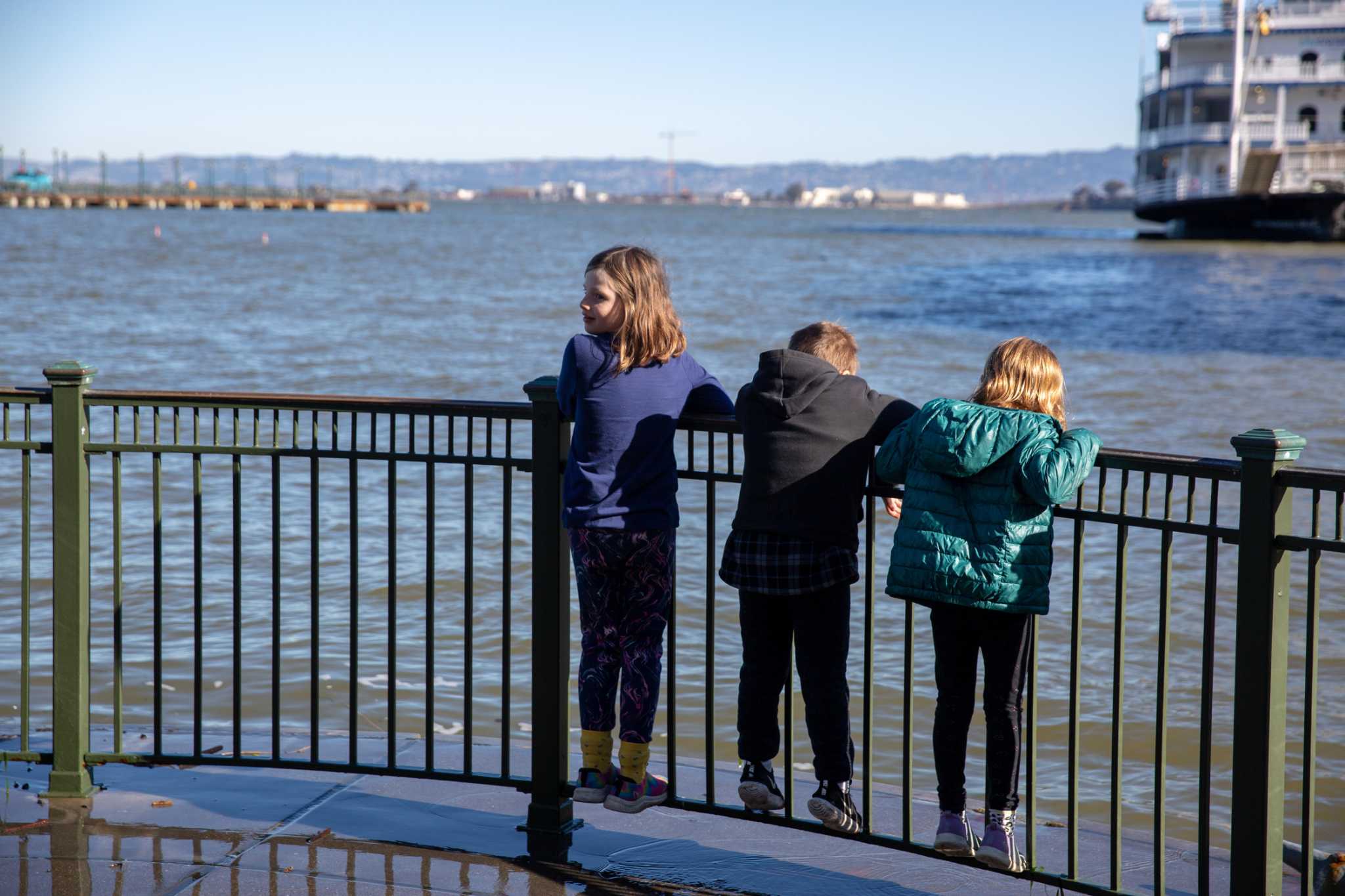 King tide watchers in San Francisco get cold feet. Wet ones, too