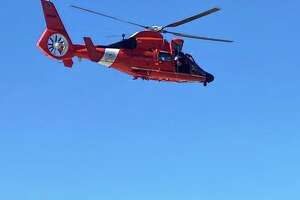 Rescuers use chopper to pluck surfer to safety amid high tide