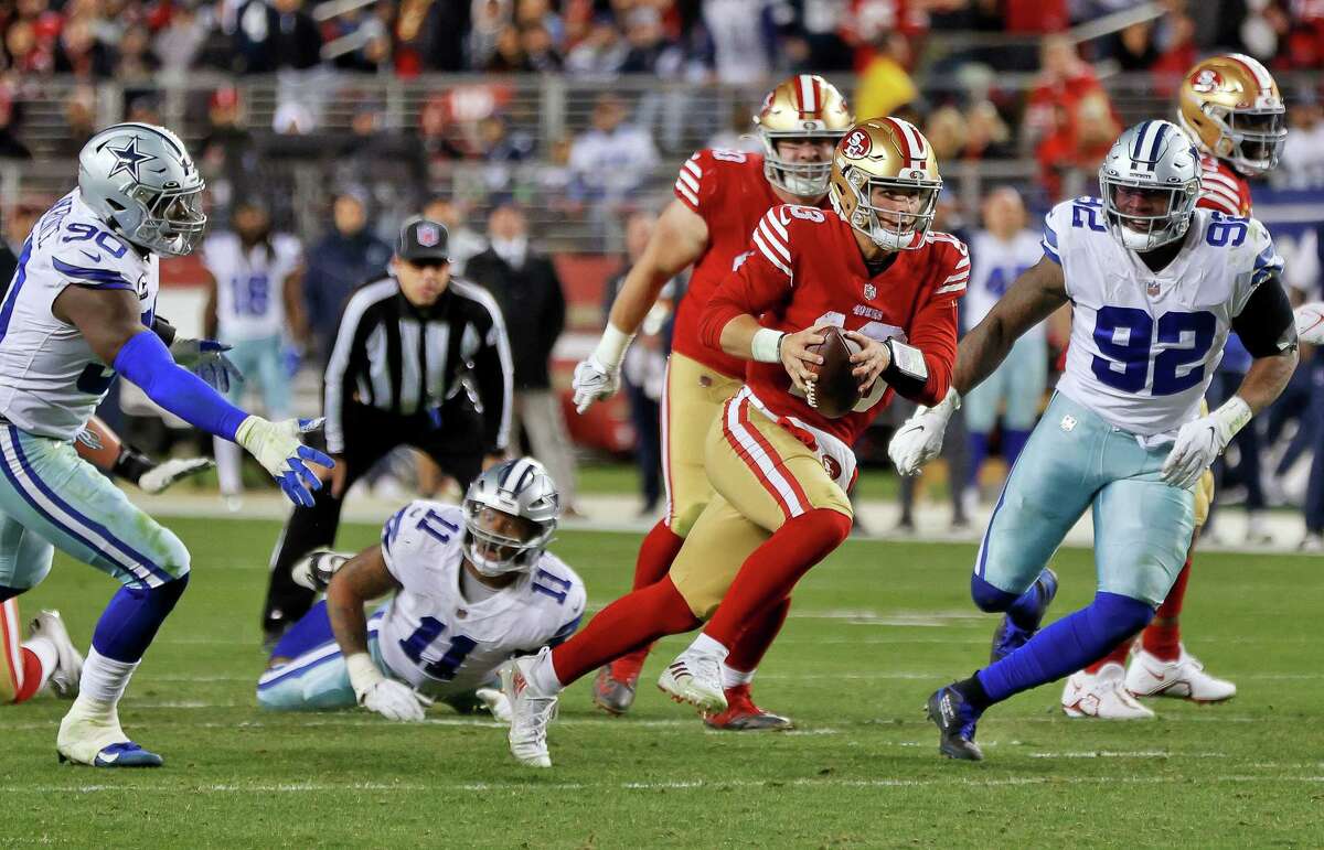 Brock Purdy (13) scrambles for a first down In the second half as the San Francisco 49ers played the Dallas Cowboys in the divisional round of the NFL Playoffs at Levi’s Stadium in Santa Clara, Calif., on Sunday, January 22, 2023.