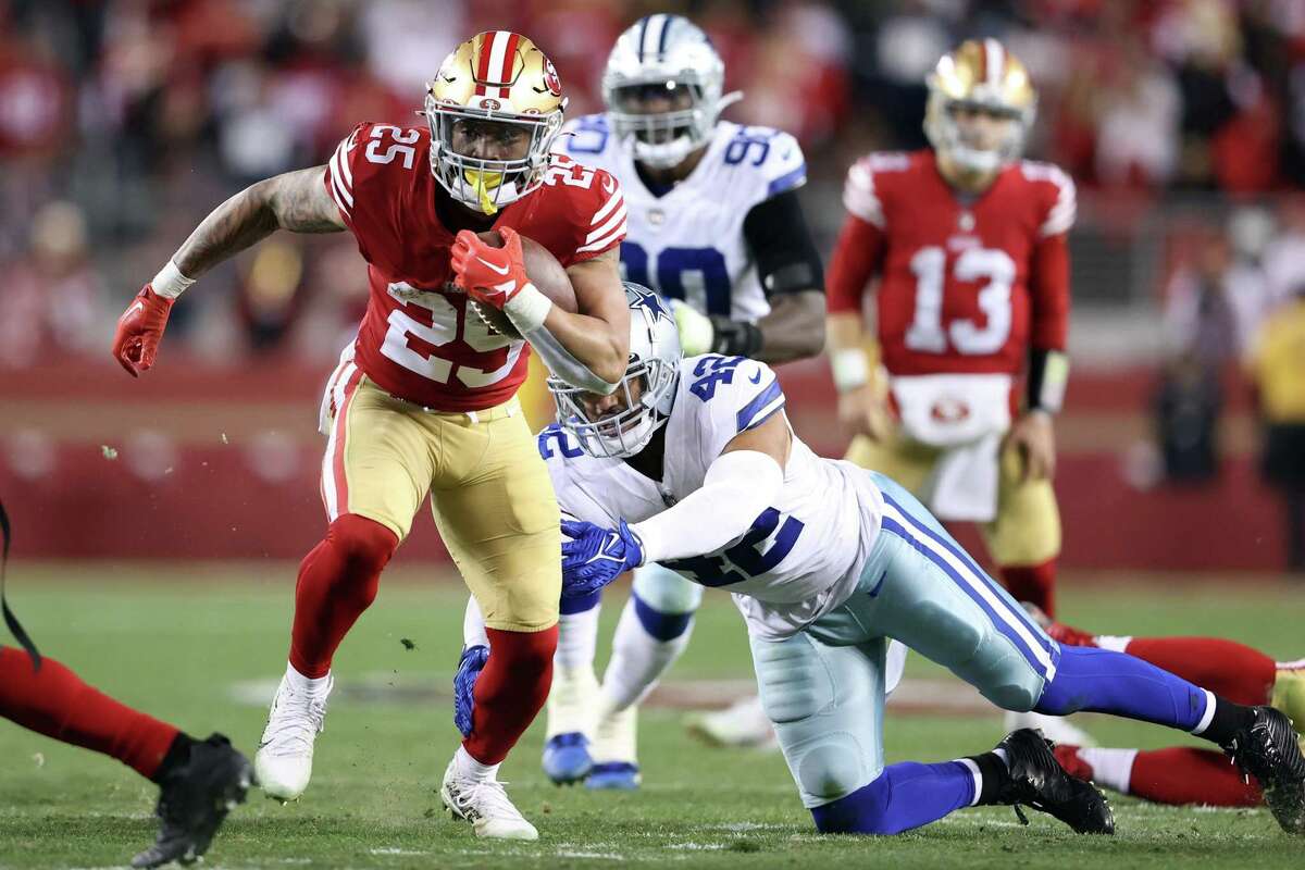 San Francisco 49ers’ Elijah Mitchell rushes past Dallas Cowboys’ Anthony Barr in 4th quarter during Niners’ 19-12 win in NFC Divisional Playoff game in Santa Clara, Calif., on Sunday, January 22, 2023.