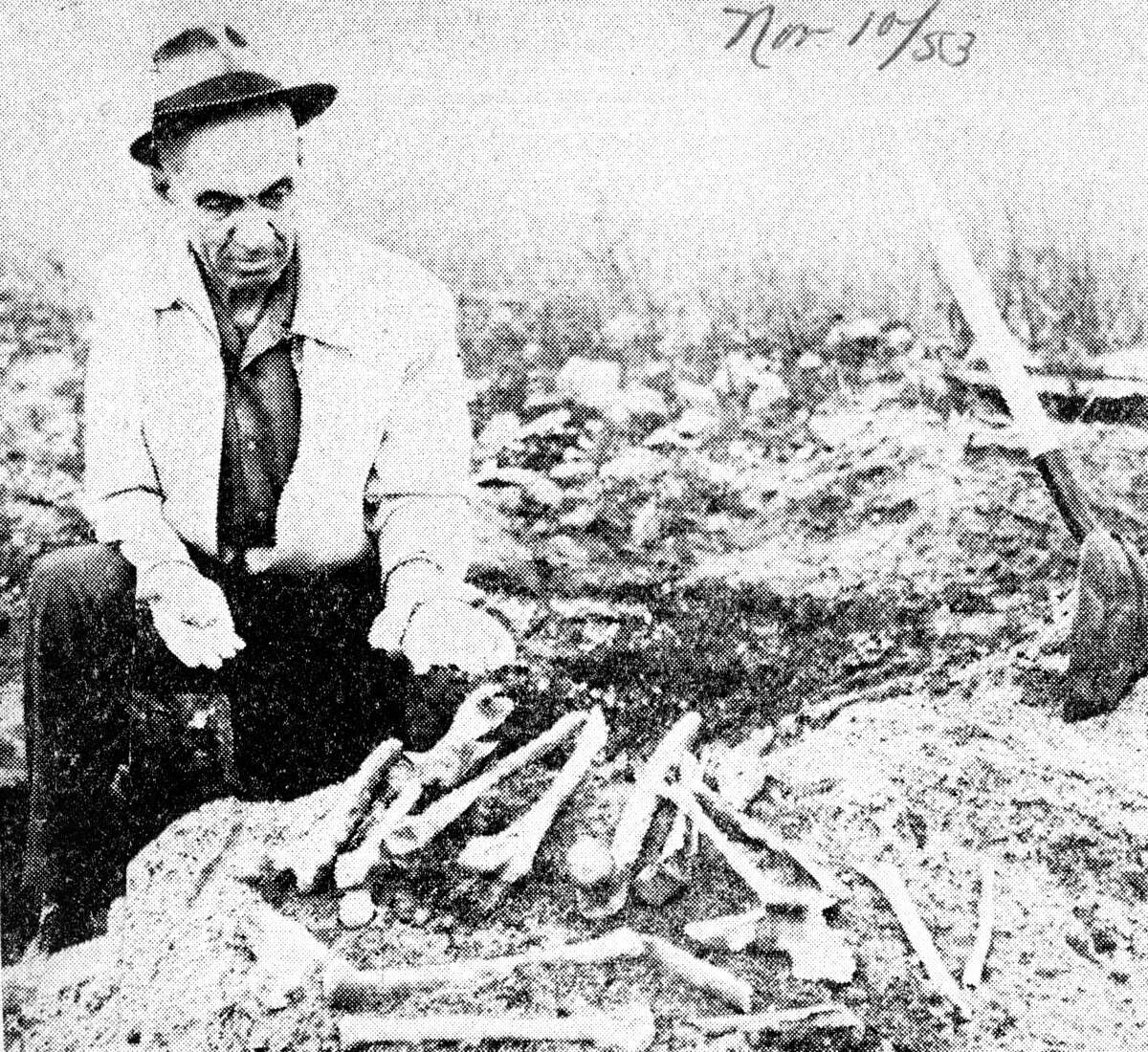 Sheriff Harry Holmgren shows some of the nearly 40 human bones unearthed on the Louis Sands property, just off Ashland Street, at East River Street. The photo accompanied an article that was published in the News Advocate on November 10, 1953.