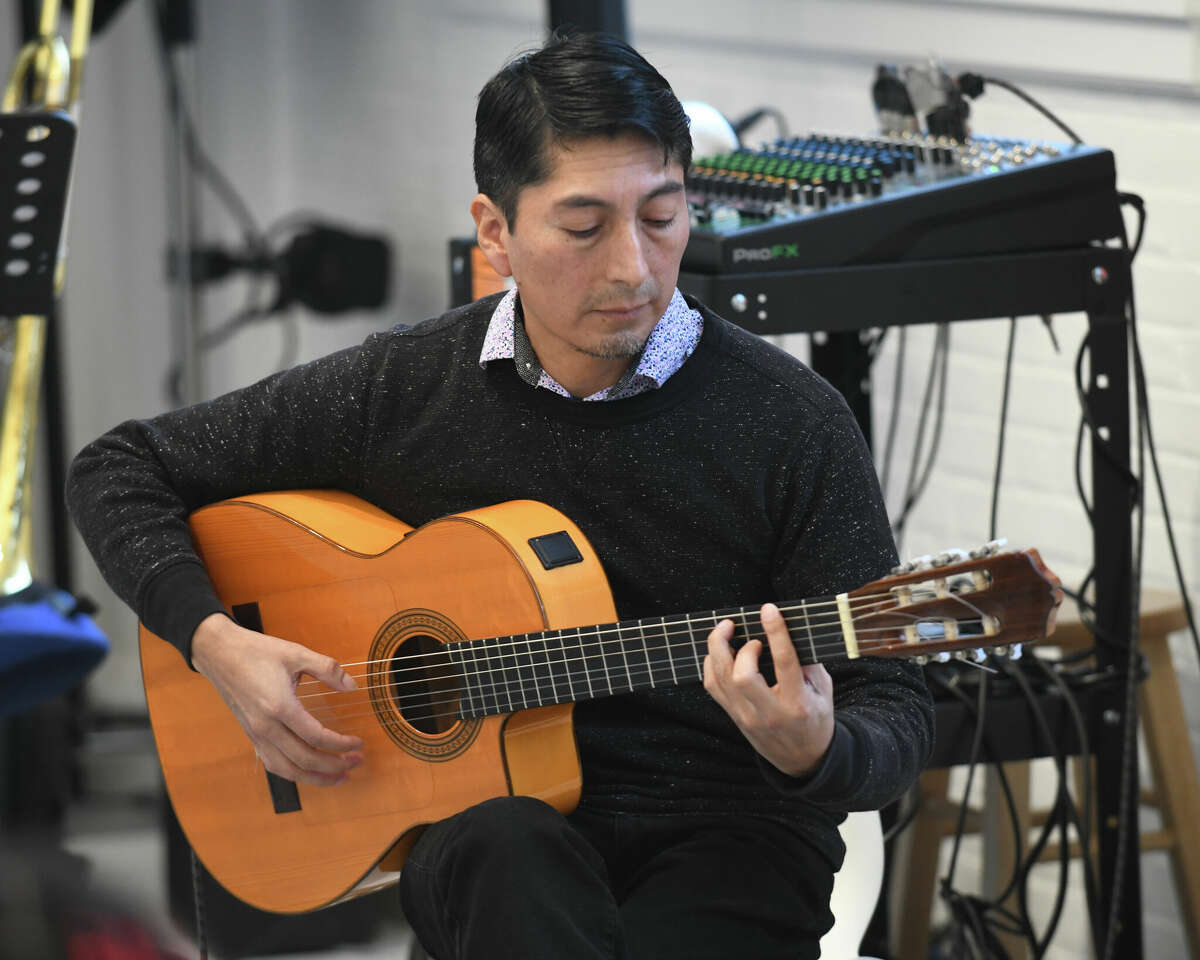 Geo Suquillo plays guitar during the Petty-Drayton Music Program kick-off event at the Norwalk Art Space in Norwalk, Conn. Sunday, Jan. 22, 2023. The event featured student performances with the world renowned musician Charley Drayton. Directed by INTEMPO, the program provides free music education to under-served elementary through middle school students.
