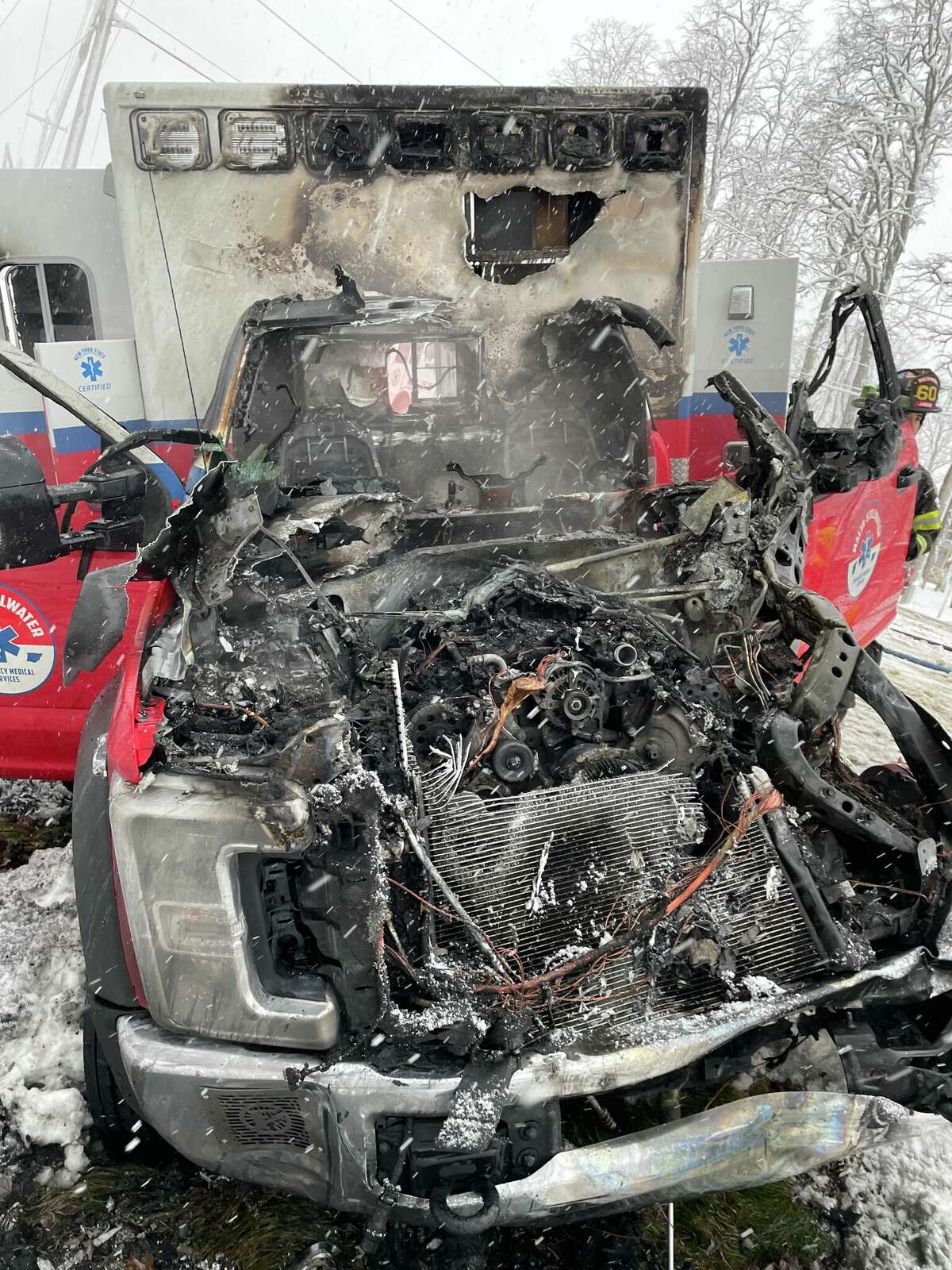 A paramedic and an emergency medical technician were hospitalized after pulling a patient from a Malta-Stillwater EMS ambulance that caught fire after a crash Monday on Route 9, authorities said.