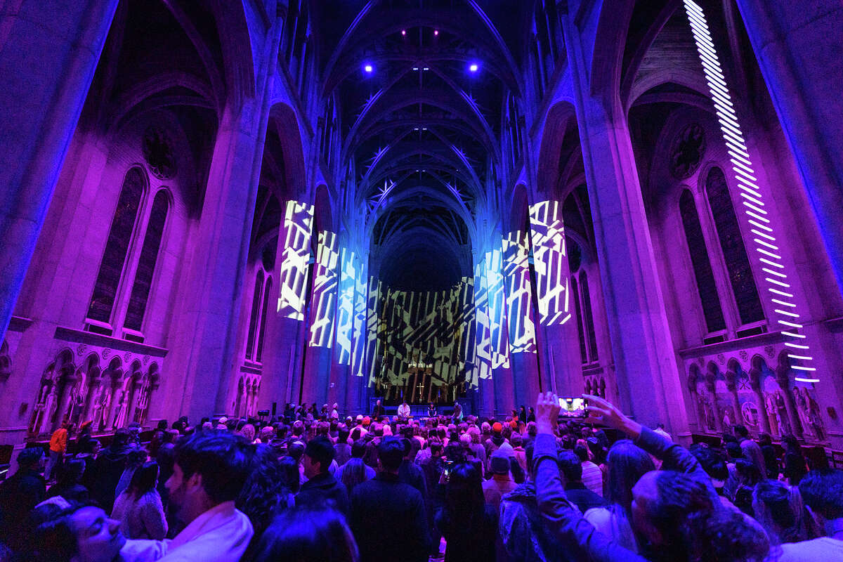 A light show is projected on the columns of the church as Cold Beat performs inside Grace Cathedral in San Francisco on Jan. 20, 2023.