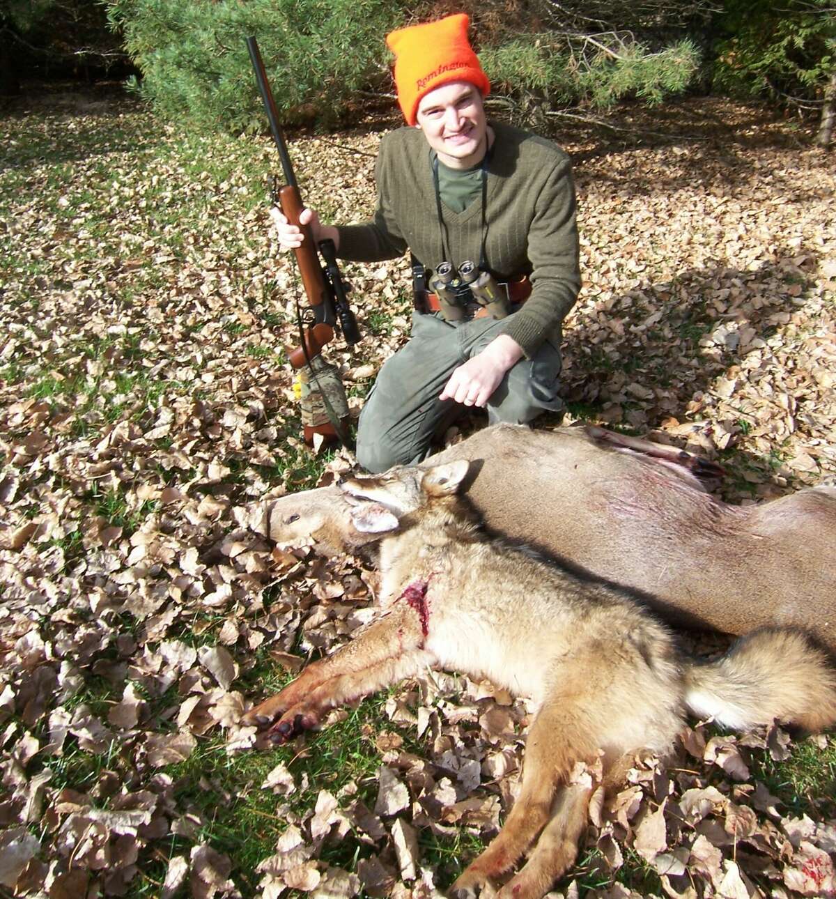 Josh Lounsbury shows the Thumb coyote and doe that he shot within seconds of each other on the opening morning of the 2009 firearm deer season.