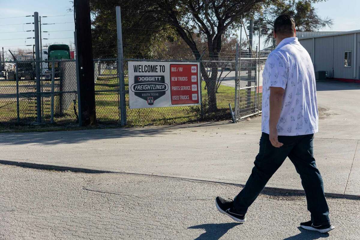 San Antonio truck driver Rolando Denova Jr. walks past the entrance to Doggett Freightliner South Texas in Converse.