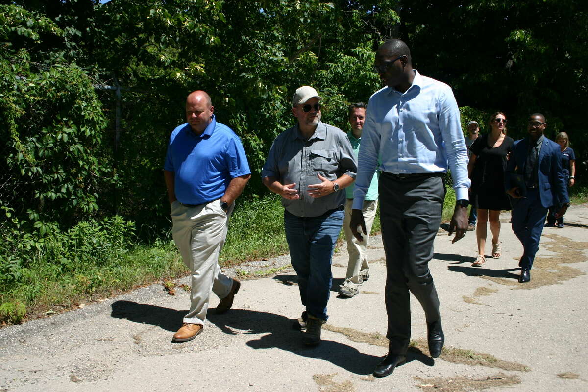 Lt. Gov. Garlin Gilchrist (right) tours the Reed City waste water treatment plant, which will be dismantled and rebuilt, with city manager Rich Saladin (left) and plant supervisor Curt Brackenrich (center) in August.