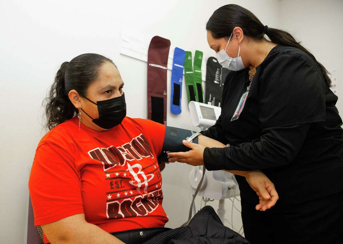 Carmelita Ramirez, certified medical assistant at UH Health Family Care Center, gets vital signs from patient Alba Jiménez before a doctor sees Jiménez Monday, Jan. 23, 2023, in Houston. Texas is among the states hit hardest by the nationwide nursing shortage, compounding the struggle for Spanish-speaking Houstonians to communicate their needs with health care providers. Both Ramirez and Jiménez speak Spanish.