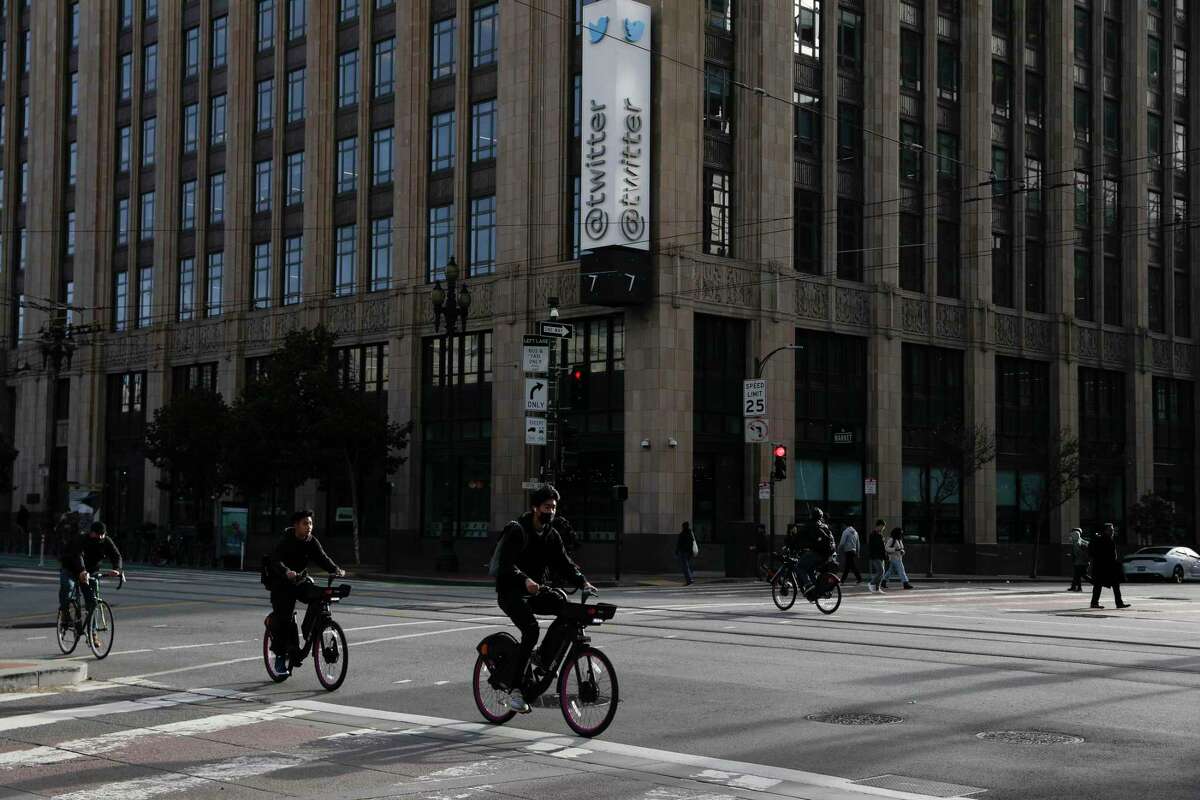 Bicyclists ride their bikes on Market Street past Twitter headquarters at 1355 Market Street in San Francisco, in November.
