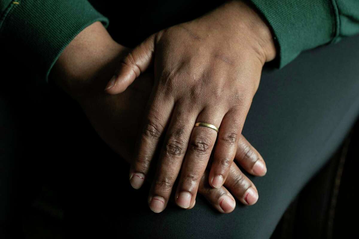 Angeline shows her wedding ring at her home in Oakland. She has spent nearly eight years trying to reunite with her son in Cameroon, where Angeline and her children faced persecution because of her sexual orientation.