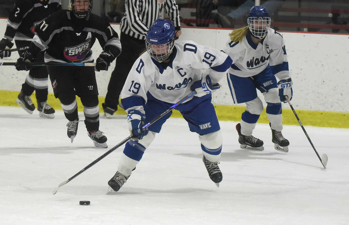 Darien's Chelsea Donovan (19) skates with the puck against Stamford/Westhill/Staples during a girls ice hockey game at the Darien Ice House on Wednesday, Jan. 18, 2023.